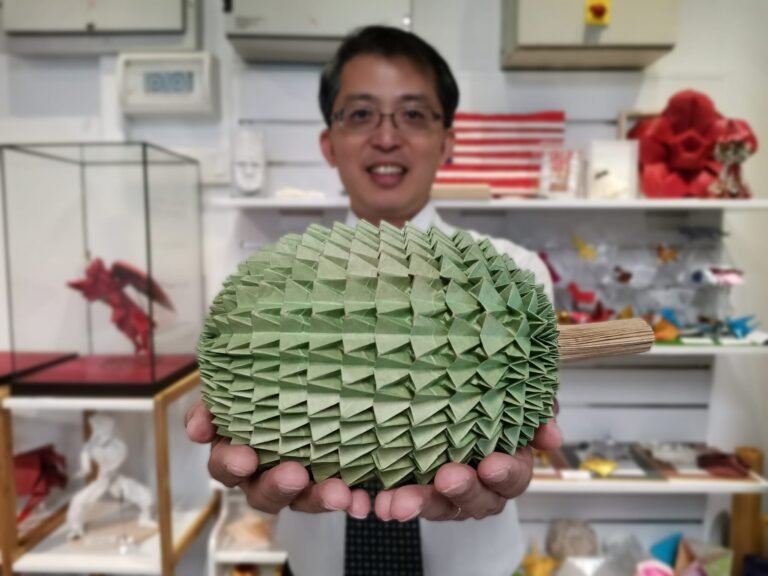 Kenneth-with-one-of-the-origami-creations-by-Sam-Yap-scaled-1